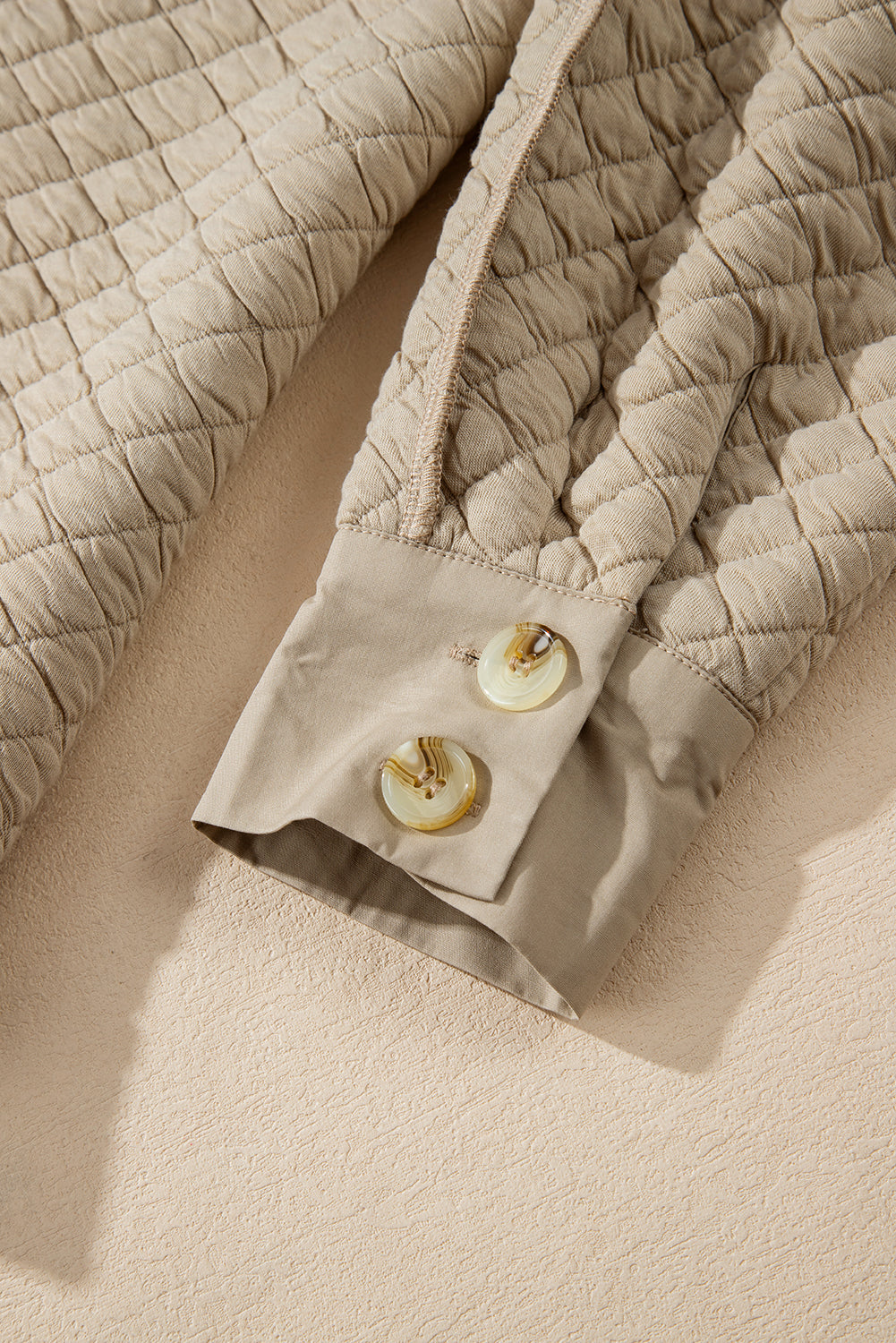 Veste matelassée boutonnée de couleur unie