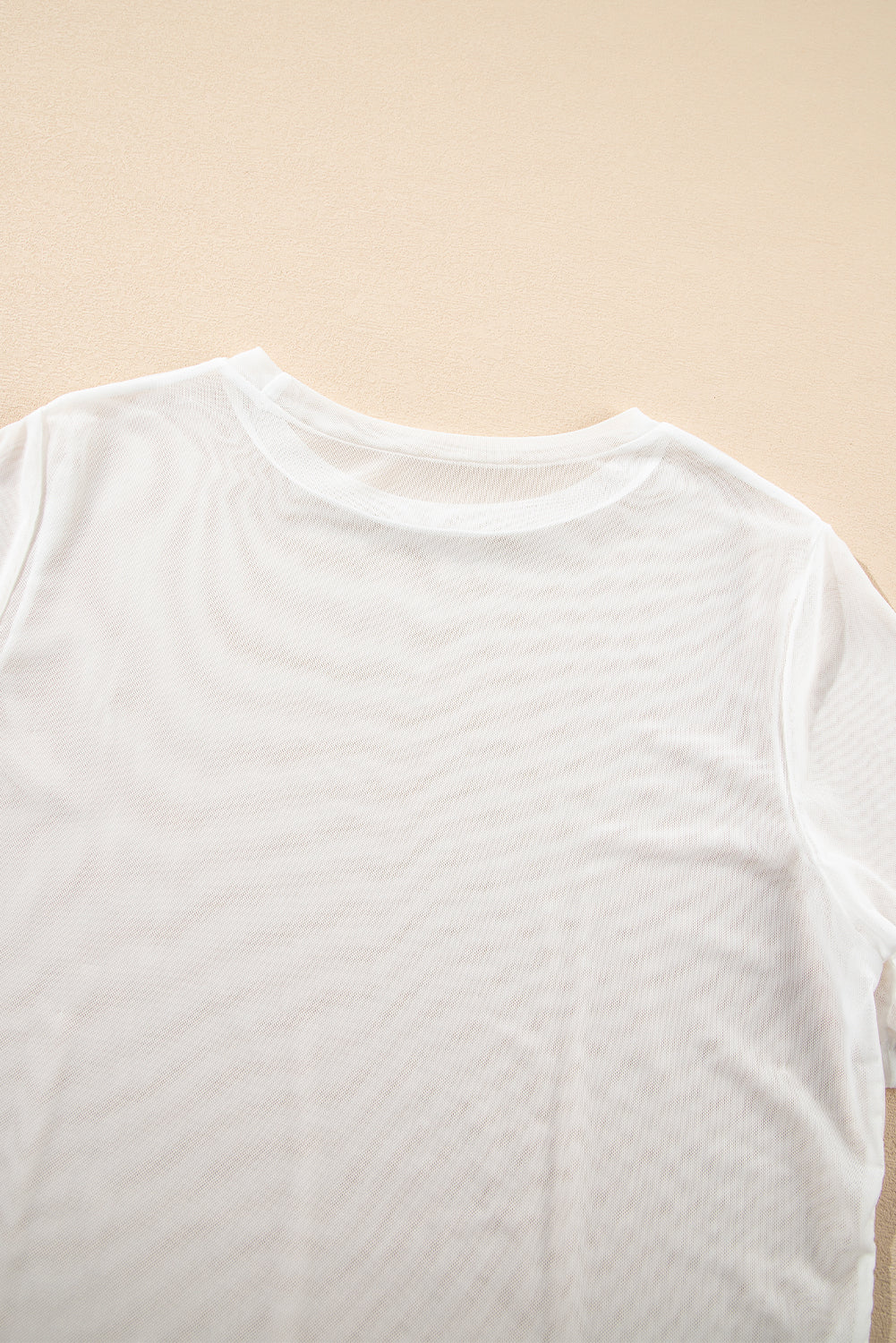 Haut à manches courtes en maille transparente de couleur unie