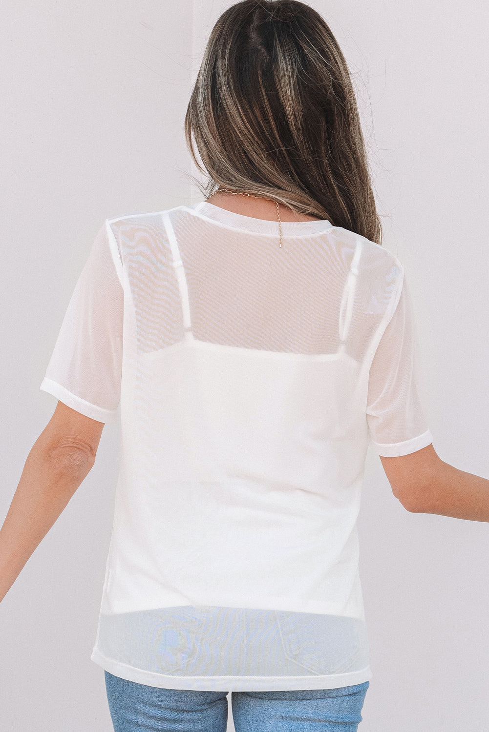 Haut à manches courtes en maille transparente de couleur unie