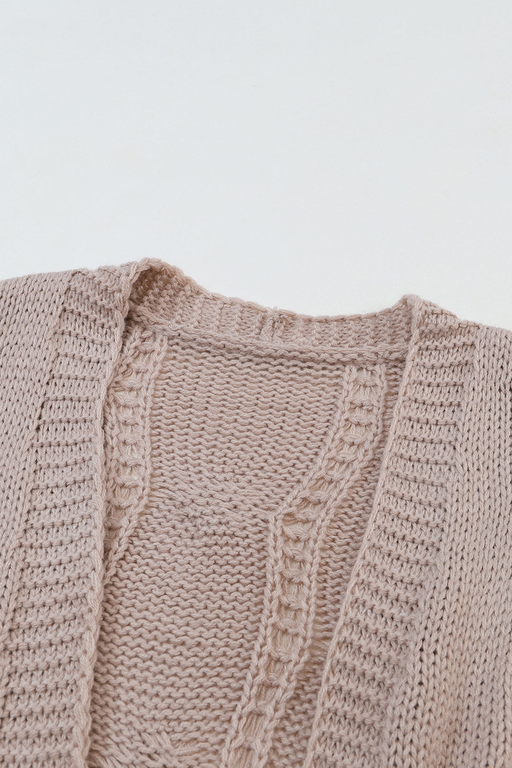 Cardigan en maille torsadée a œillets et bordure côtelée