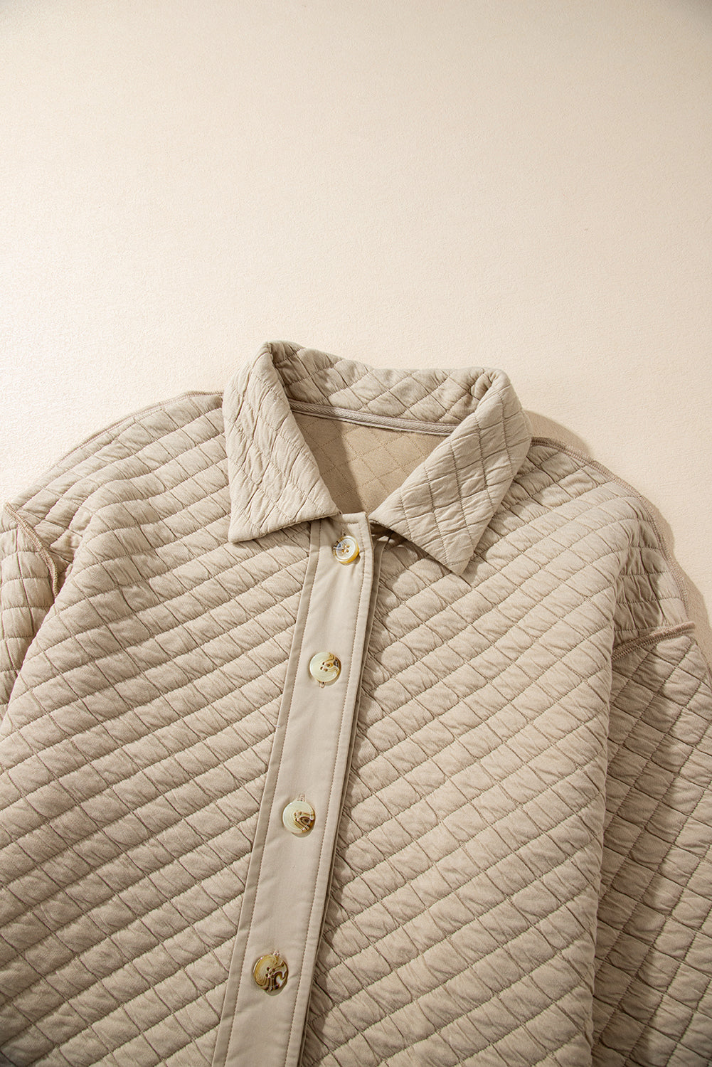 Veste matelassée boutonnée de couleur unie