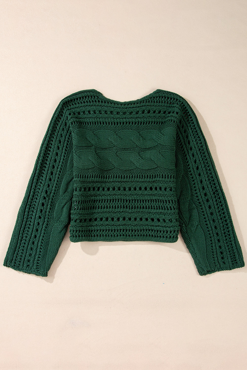 Pull court en tricot torsadé ajouré